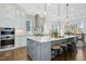 Bright kitchen with a large island, stainless steel appliances, and stylish pendant lighting at 2046 Fellini Dr, Apex, NC 27502