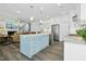 Open-concept kitchen with an island and stainless steel appliances connecting to the living area at 2046 Fellini Dr, Apex, NC 27502