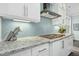 Granite countertops, white cabinets, and herringbone backsplash create a stylish kitchen space at 2046 Fellini Dr, Apex, NC 27502