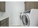 Functional laundry room featuring modern appliances, ample cabinet space, and neutral decor at 2046 Fellini Dr, Apex, NC 27502