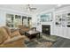 Sunlit living room with a fireplace, built-ins, and comfortable seating arrangement at 2046 Fellini Dr, Apex, NC 27502