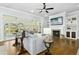 Cozy living room with fireplace, built-in shelves, and sunroom access through glass sliding doors at 2046 Fellini Dr, Apex, NC 27502