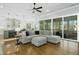 Spacious living room with modern grey sectional sofa and large glass sliding doors at 2046 Fellini Dr, Apex, NC 27502