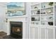 A close up of the living room's fireplace with a mounted TV and built-in shelving in a neutrally lit space at 2046 Fellini Dr, Apex, NC 27502