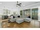 Spacious living room with modern grey sectional sofa and large glass sliding doors at 2046 Fellini Dr, Apex, NC 27502