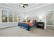 Bright main bedroom with tray ceiling, large windows, and a luxuriously appointed ensuite bathroom at 2046 Fellini Dr, Apex, NC 27502
