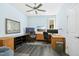 Bright home office featuring custom desk, ample storage, and great natural light from a large window at 2046 Fellini Dr, Apex, NC 27502