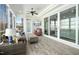 Bright sunroom featuring multiple seating options, tongue and groove ceiling, and large windows at 2046 Fellini Dr, Apex, NC 27502