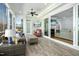 Cozy sunroom with tile floors, comfortable seating, and sliding glass doors to the living room at 2046 Fellini Dr, Apex, NC 27502
