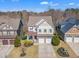 An aerial view of a two-story house with a two-car garage and a beautifully landscaped front yard at 205 Virginia Water Dr, Rolesville, NC 27571
