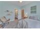 Bedroom with a relaxing chair, and light blue walls, and a view to the en-suite bathroom at 205 Virginia Water Dr, Rolesville, NC 27571