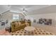 Large bonus room with an olive sofa, a desk, a ceiling fan and playroom furnishings at 205 Virginia Water Dr, Rolesville, NC 27571