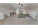 Spacious bonus room has ample seating, a television, and a storage unit for toys and games at 205 Virginia Water Dr, Rolesville, NC 27571