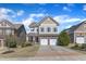 Charming two-story home featuring a two-car garage, landscaped front yard, and inviting entrance at 205 Virginia Water Dr, Rolesville, NC 27571