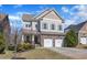Charming two-story home featuring a two-car garage and landscaped front yard at 205 Virginia Water Dr, Rolesville, NC 27571