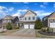 Charming two-story home featuring a two-car garage, landscaped front yard and inviting entrance at 205 Virginia Water Dr, Rolesville, NC 27571