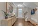 Elegant foyer featuring hardwood floors, stylish console table, and staircase with modern decor at 205 Virginia Water Dr, Rolesville, NC 27571