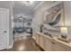 Hallway featuring a wooden console and view of the spacious, sunlit living room and stairs at 205 Virginia Water Dr, Rolesville, NC 27571