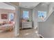 Upstairs hallway with a decorative chest and a view of a cozy bedroom at 205 Virginia Water Dr, Rolesville, NC 27571