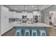 Stylish kitchen features an oversized island with bar stool seating and stainless steel appliances at 205 Virginia Water Dr, Rolesville, NC 27571