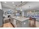 Spacious kitchen with center island and dining area, seamlessly connected to the living room at 205 Virginia Water Dr, Rolesville, NC 27571