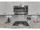 Close-up of gourmet kitchen with stainless steel appliances and granite countertops and stove top at 205 Virginia Water Dr, Rolesville, NC 27571