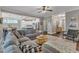 Spacious living room with open floor plan, a gray sectional, and views of the kitchen at 205 Virginia Water Dr, Rolesville, NC 27571
