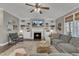 Cozy living room with built-in shelving surrounding a fireplace, large sectional, and lots of natural light at 205 Virginia Water Dr, Rolesville, NC 27571