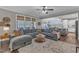 Open concept living room flows into kitchen; it features large sectional and decorative rug at 205 Virginia Water Dr, Rolesville, NC 27571