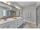 Luxurious main bathroom with a double vanity, framed mirror, and glass-enclosed shower at 205 Virginia Water Dr, Rolesville, NC 27571