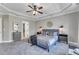 Spacious main bedroom featuring a ceiling fan, soft carpet, and an ensuite bathroom at 205 Virginia Water Dr, Rolesville, NC 27571