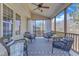 Comfortable screened porch boasts ceiling fan, cozy seating and a view to nature at 205 Virginia Water Dr, Rolesville, NC 27571