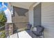 Inviting porch with stone pillars and black wrought iron chairs and railings for relaxing at 205 Virginia Water Dr, Rolesville, NC 27571