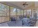 View of relaxing screened porch with comfortable wicker seating and views of wooded backyard at 205 Virginia Water Dr, Rolesville, NC 27571