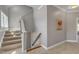 Carpeted stairs with wood handrail lead to the upper level with fresh paint and natural light at 205 Virginia Water Dr, Rolesville, NC 27571