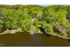 Lakeside home with trees, a dock and gazebo, and a clear view of the lake at 2140 N Lakeshore Dr, Chapel Hill, NC 27514