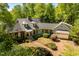 Charming home with lush landscaping, brick driveway and garage, captured from above at 2140 N Lakeshore Dr, Chapel Hill, NC 27514