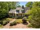 Aerial view of a brick house with a brick driveway surrounded by mature landscaping at 2140 N Lakeshore Dr, Chapel Hill, NC 27514