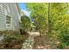 Beautiful backyard featuring a stone pathway leading to the lush landscaping and the home's exterior at 2140 N Lakeshore Dr, Chapel Hill, NC 27514