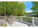 Backyard deck overlooking a well-maintained lawn and lake view at 2140 N Lakeshore Dr, Chapel Hill, NC 27514