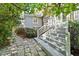 Stone patio leading to a back porch and upper level patio at 2140 N Lakeshore Dr, Chapel Hill, NC 27514