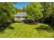 Scenic backyard with a sprawling lawn and mature trees providing privacy at 2140 N Lakeshore Dr, Chapel Hill, NC 27514