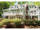 Spacious back porch and backyard with mature shrubbery, and lots of windows at 2140 N Lakeshore Dr, Chapel Hill, NC 27514