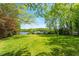 Expansive backyard with a lush lawn and access to the lake, perfect for outdoor activities and relaxation at 2140 N Lakeshore Dr, Chapel Hill, NC 27514