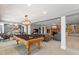 Basement with a billiards table, fireplace, and seating area, creating an inviting space at 2140 N Lakeshore Dr, Chapel Hill, NC 27514