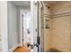 Bathroom featuring tiled walk-in shower with glass door and bench at 2140 N Lakeshore Dr, Chapel Hill, NC 27514