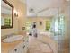 Bathroom featuring double sinks, a walk-in shower, and a soaking tub at 2140 N Lakeshore Dr, Chapel Hill, NC 27514