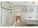 Bathroom featuring a clawfoot tub, tiled shower, mosaic floors, and an open view to the bedroom at 2140 N Lakeshore Dr, Chapel Hill, NC 27514