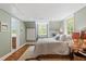 Bedroom featuring hardwood floors, a built-in desk and shelving, a comfortable bed, and natural light at 2140 N Lakeshore Dr, Chapel Hill, NC 27514