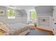 Cozy bedroom featuring wainscoting, a blue patterned rug, and plenty of natural light from two large windows at 2140 N Lakeshore Dr, Chapel Hill, NC 27514